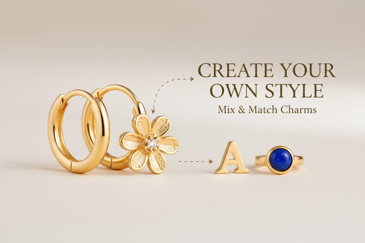 ein kleiner goldener Kreole woran ein Blumen charm dran ist, sodass man erkennt man kann mix and Match machen und sich seine eigenen Ohrringe zusammen stellen 